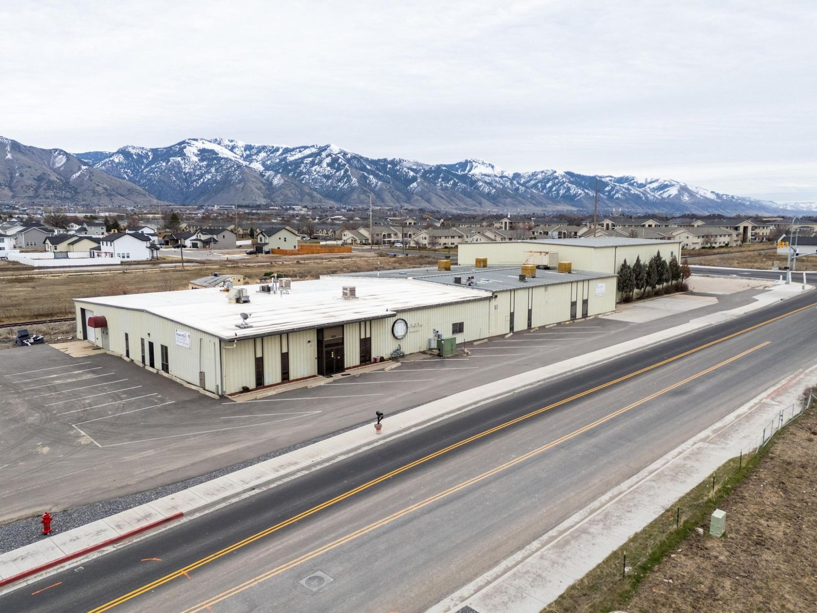 Aerial view of the 600 West Flex warehouse with the Wasatch Range behind it